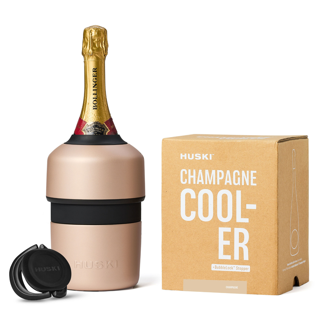 HUSKI champagne cooler with a bottle of champagne and packaging on a white background