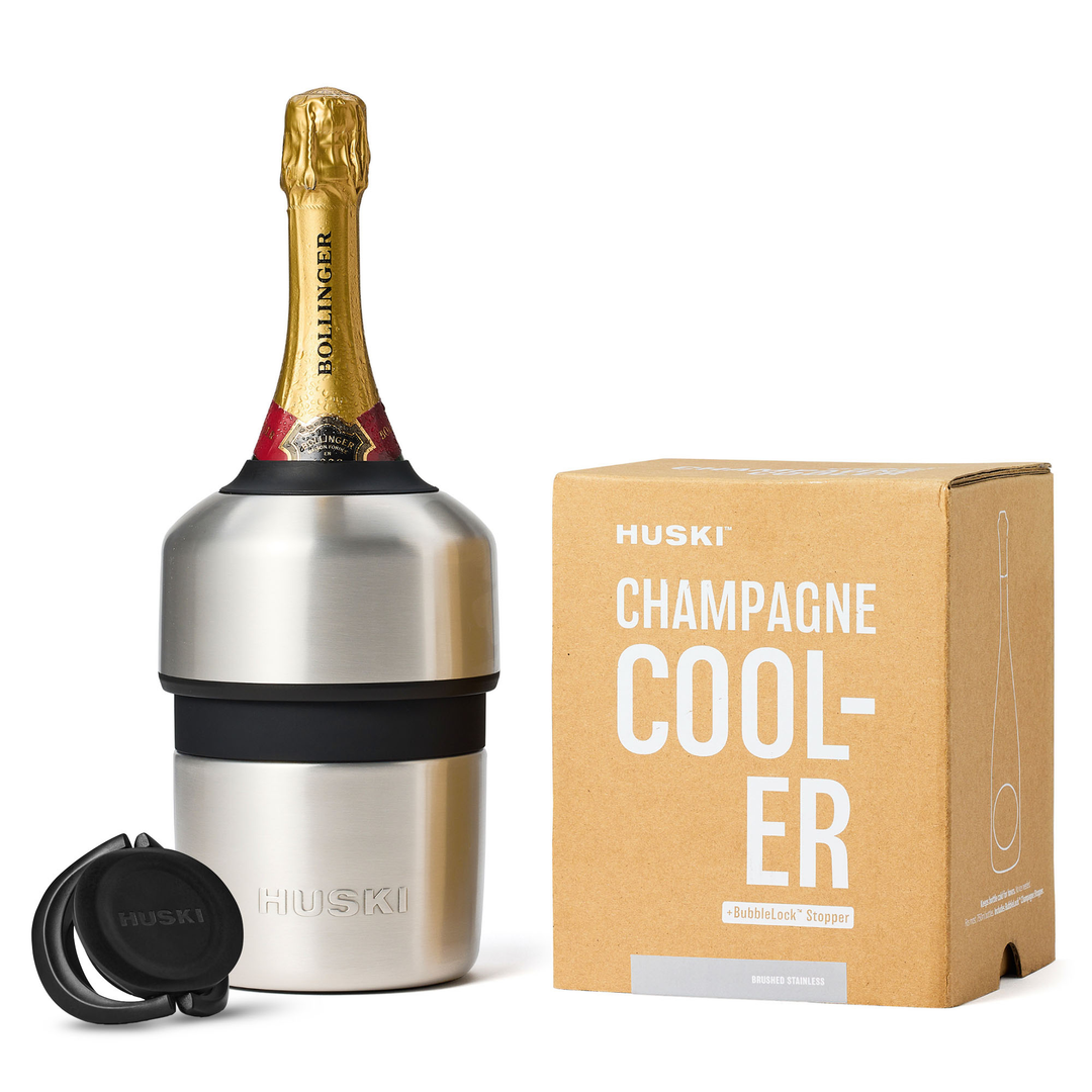 HUSKI champagne cooler with a bottle of champagne and packaging on a white background