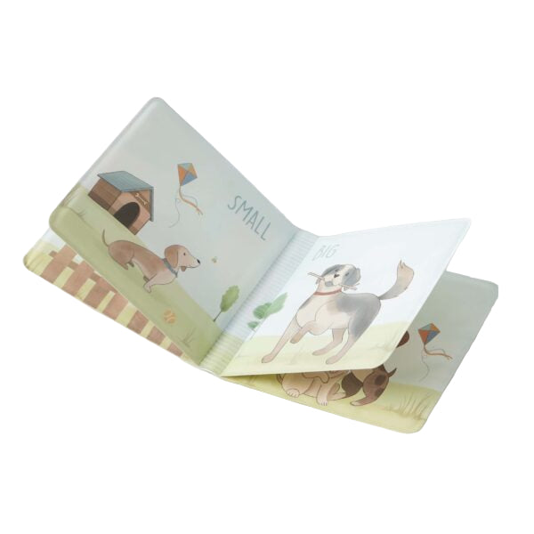 Open children's book with illustrations of dogs and a doghouse on a light gray background