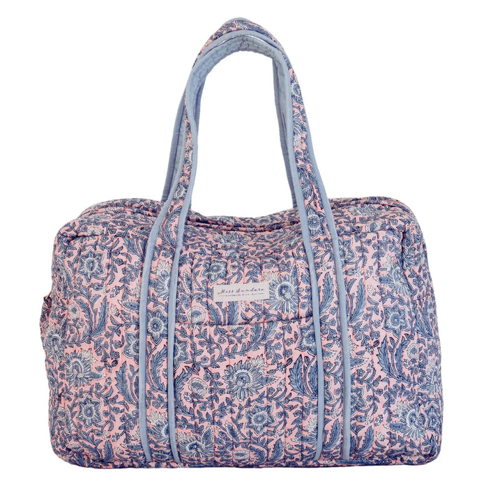 Quilted organic cotton  weekend bag External pocket Internal pockets Hand block printed Padded straps Bronze gold metal zip Zipper adorned with printed bow