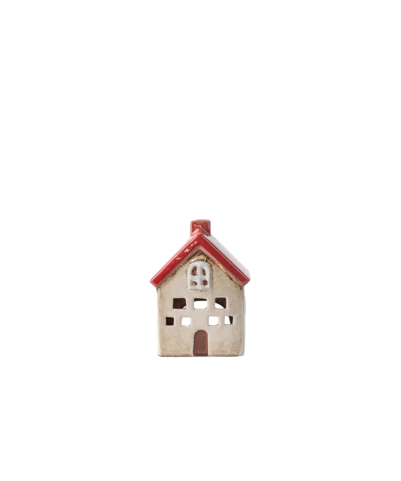 Small ceramic house with a red roof on a white background