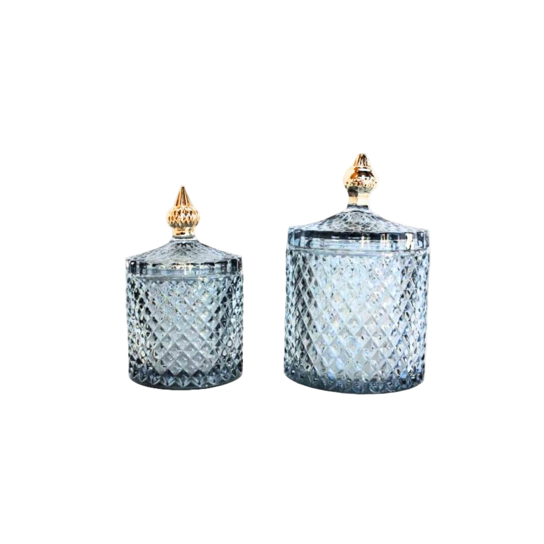 Diamond patterned glass cylinder shape jar with feature gold top to lid. 