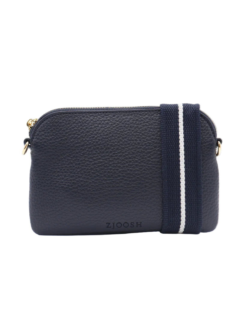 A navy-colored, leather Missy Hugo Cross Body Bag with a white webbing cross body strap and a detachable wristlet.