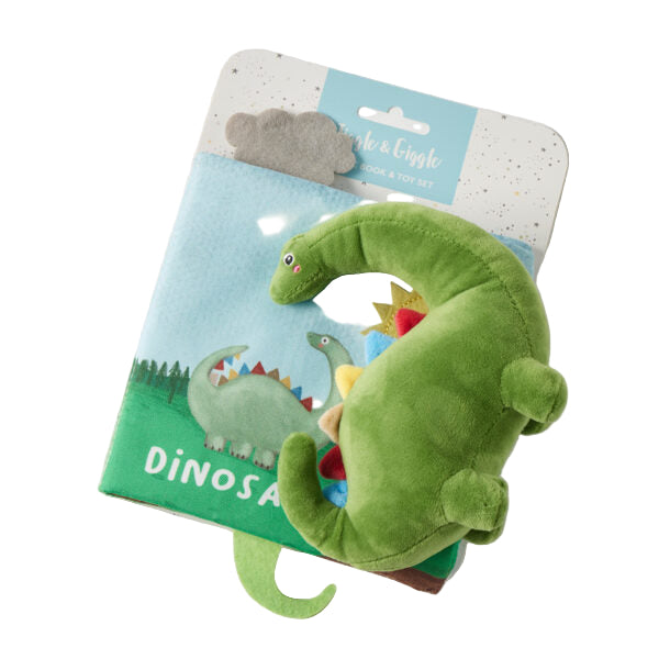 Green dinosaur plush toy on a colorful dinosaur-themed book 